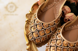 Elegant Golden Juttis with Black Accents and Moti & Zardozi Embellishments For Women